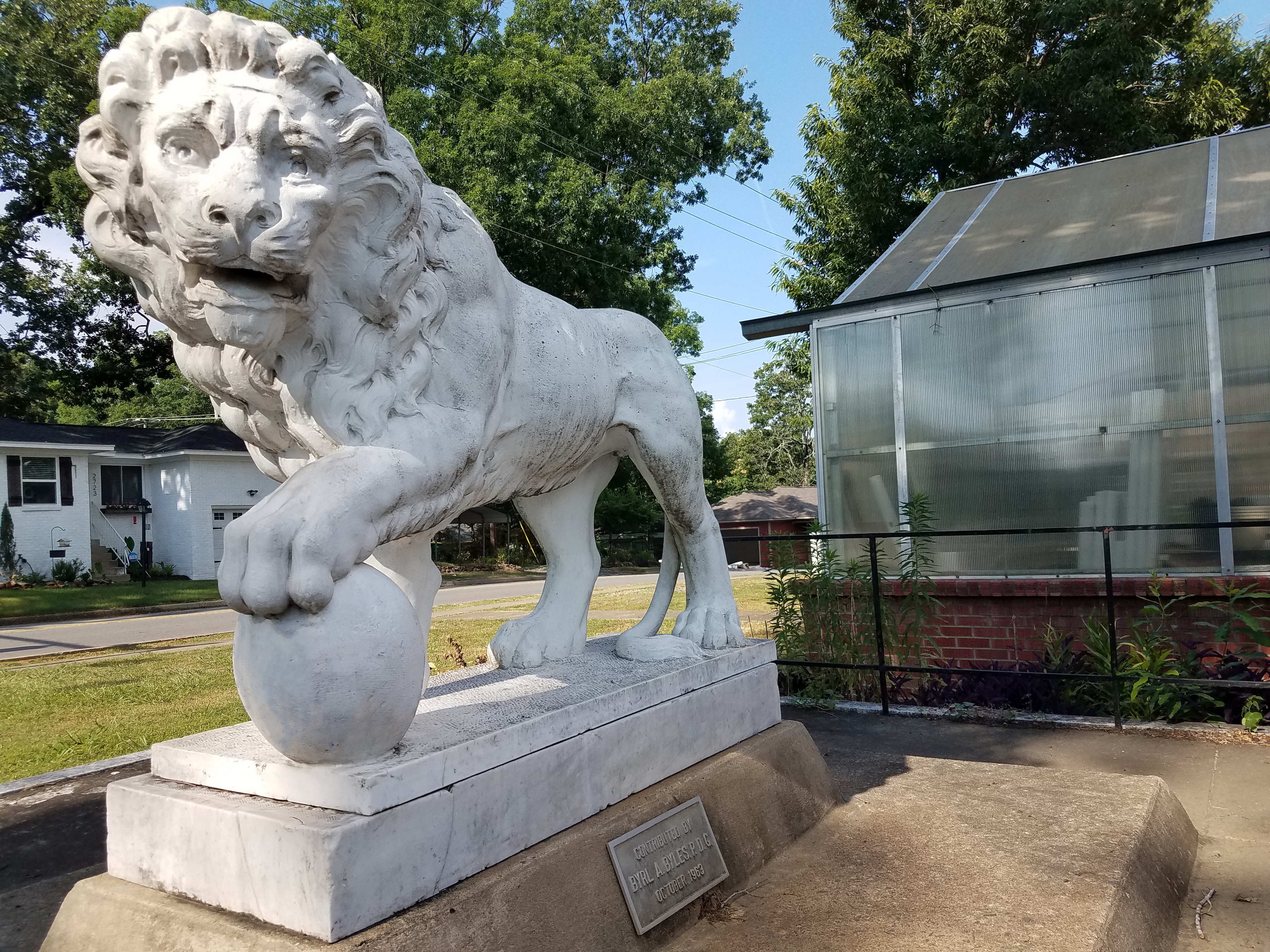Color photograph of the marble lion statue on the WSB campus
