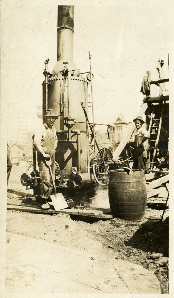 Arcade construction workers stand next to machinery. From: Calvin Hanna Collection