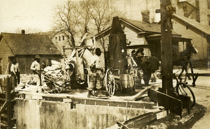 Workers are constructing the foundation for the City Market and Arcade building. From: Calvin Hanna Collection