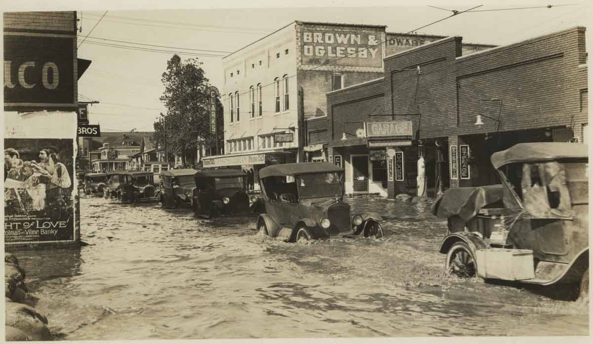 Cars driving through flooded street in North Little Rock, 1927 Cars driving through flooded street in North Little Rock, 1927