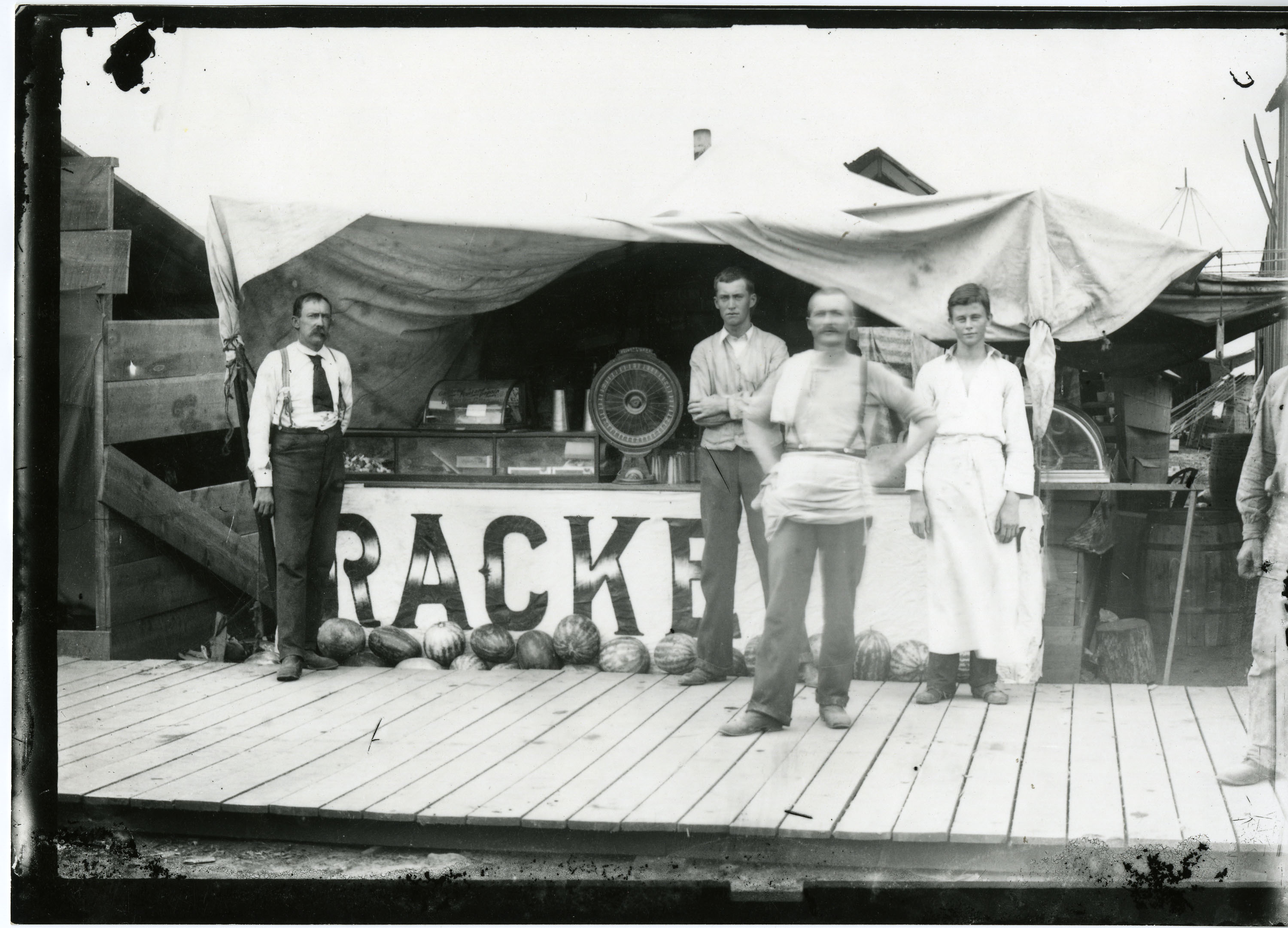 "Tent city," employees in front of tented store, "Racke," selling watermelon, Mena, 1896 "Tent city," employees in front of tented store, "Racke," selling watermelon, Mena, 1896