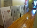 Five exhibit boards lined up against a wall