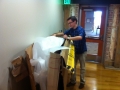An unidentified male worker standing with packing materials