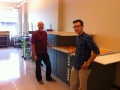 Tom Clifton, chair of the UA Little Rock Art Department, standing next to an unidentified standing male worker