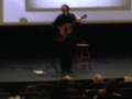 An unidentified male solo guitarist on stage in a blurred image