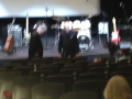 Two WS Holland band members walking across a stage