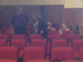 Four unidentified individuals in a theater, blurred image