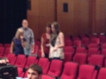 Five unidentified individuals in a theater, blurred image