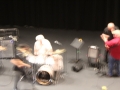 Three unidentified male members of a band on a stage, blurred image