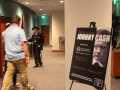 Three individuals and one Johnny Cash poster board in the Ron Robinson Theater lobby