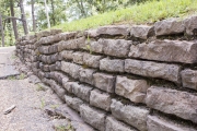 Stone retaining wall along roadway.