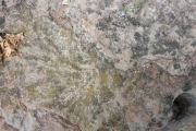 Stair step with rock drill hole and dynamite blast mark.