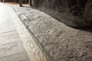 Close up of stone hearth inside cabin.
