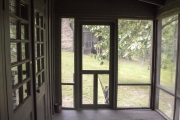 Screened-in back porch on cabin.