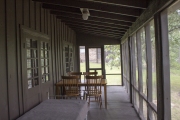 Furniture on screened-in porch.