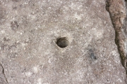 Rock drill hole in front step of cabin.