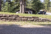 Rock retaining wall along roadway.