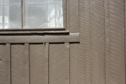 Exterior windowsill and saw marks on cabin exterior.