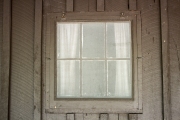 Window with screen on front porch of lodge.