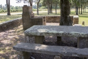 Picnic table, outdoor over, and stone enclosure at Big Flat City Park.