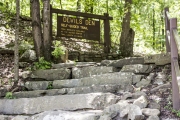 The Devil’s Den Trailhead sign near the Lee Creek bridge