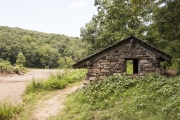 Rear view of the CCC Well House building along Lee Creek