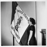 Jeannette looking at flag for U.S. Savings Bonds