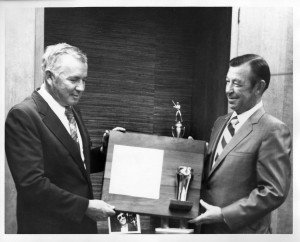 Hall receives an award from a vice-president of Coca Cola, ca. 1973