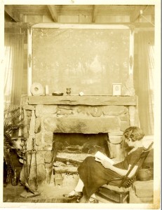 Babcock in rocking chair reading at Broadview on Highway 10, undated