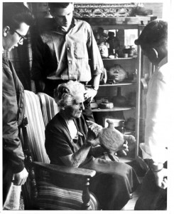 Babcock Cleaning Artifact with Three Students Watching, undated