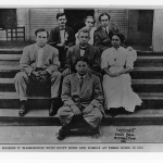 Dr. Booker T. Washington with Scott Bond and his family at Bond's family home, black and white photo.