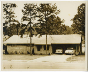 Ranch-style house with two vehicles in the carport of Max Howell residence at 7 Broadmoor Drive in Little Rock.