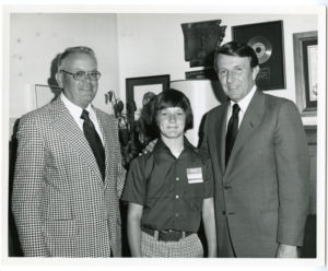 Max Howell, Dale Bumpers, and unidentfied male child pose for a group photograph.