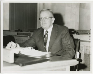 Max Howell sitting at his desk in the Arkansas State Senate.