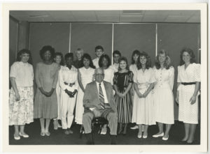 Max Howell poses with a fourteen high school men and women who were awarded $1,000 scholarships to attend college. The money was raised from the annual Max Howell roast.