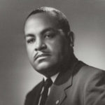 Dr. Leroy Christophe poses for a seated portrait.