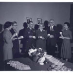 Huckaby stands in a line of Central High faculty and a 101st Airborne officer at an event labeled as a faculty tea.