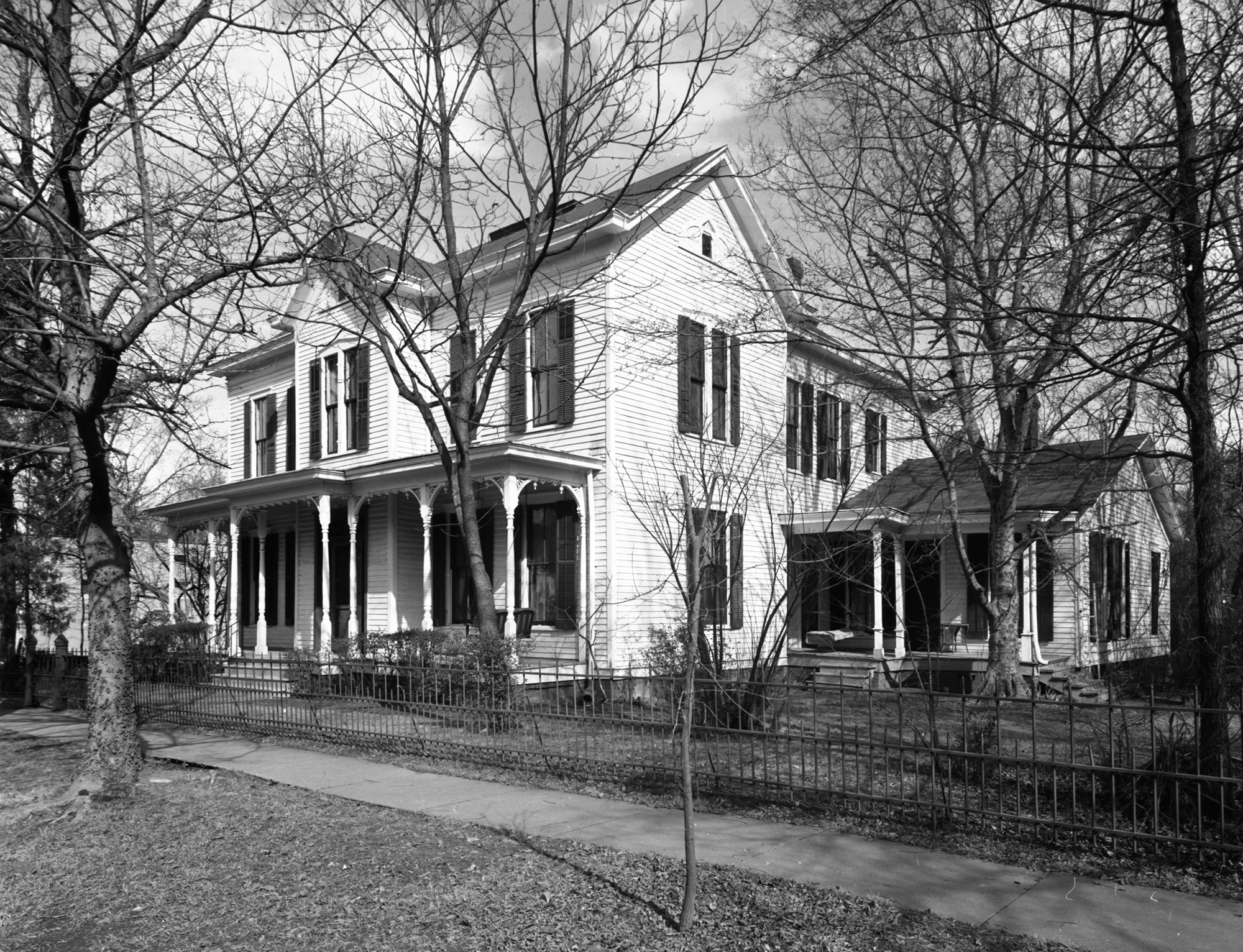 Reichardt House, 1968 Black and white photograph showing the exterior of the Reichardt House. It is a two-story home with a covered front porch and addition on the side