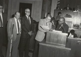 Dr. Townsend presents a citation recognizing the 40th anniversary of Arkansas Enterprises for the Blind, March 1987