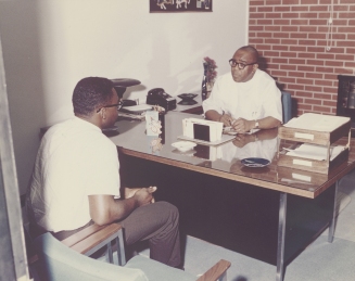 Dr. Townsend talks with a patient at his clinic on Wright Ave, early 1980s