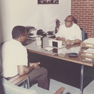 Dr. Townsend talks with a patient at his clinic on Wright Ave, early 1980s
