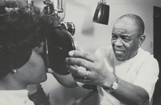 Dr. Townsend gives an eye exam to a patient, 1979