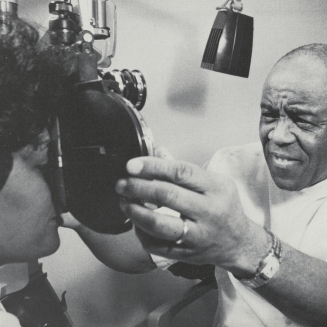 Dr. Townsend gives an eye exam to a patient, 1979