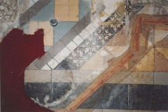 Damaged and removed red carpet showing previously covered encaustic tile on the floor of the apse,  2004