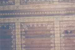 A close up of the state of the stenciling on the wooden ceiling above the aisles, August 2004