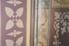 Newly done wall stenciling (left) with unpreserved stenciling of the ceiling (right), ca. 2007-2009