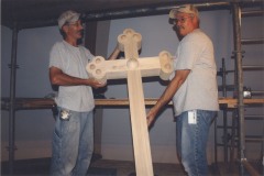Two woodworkers showing off a completed cross for the restoration, April 2009