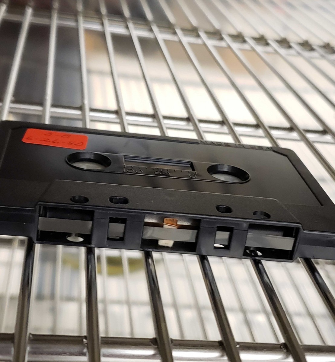 A cassette tape from the 1980 Convention inside the scientific oven. You can see that its felt pressure pad is beginning to come off