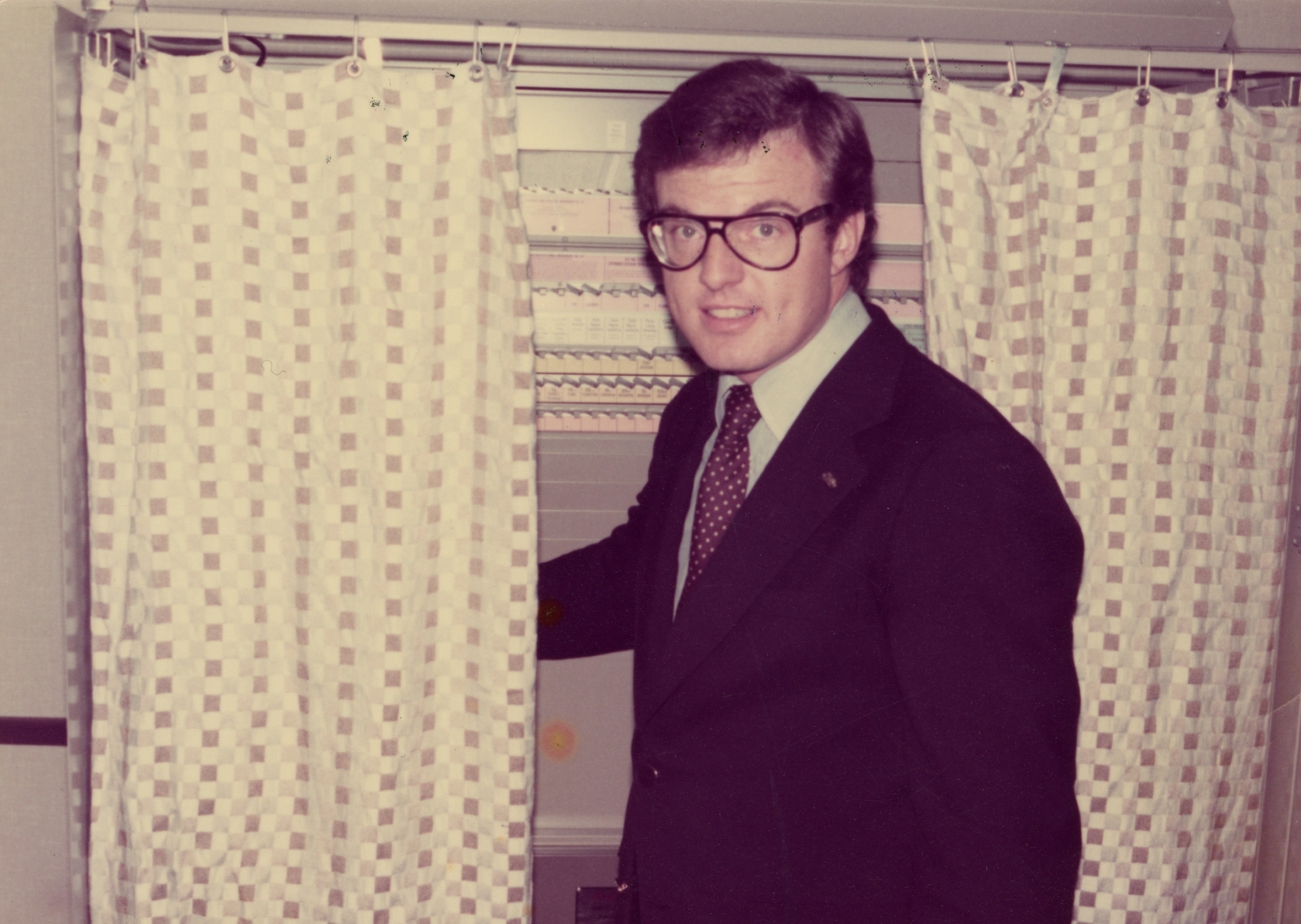 Jim Guy Tucker in a voting booth, 1976