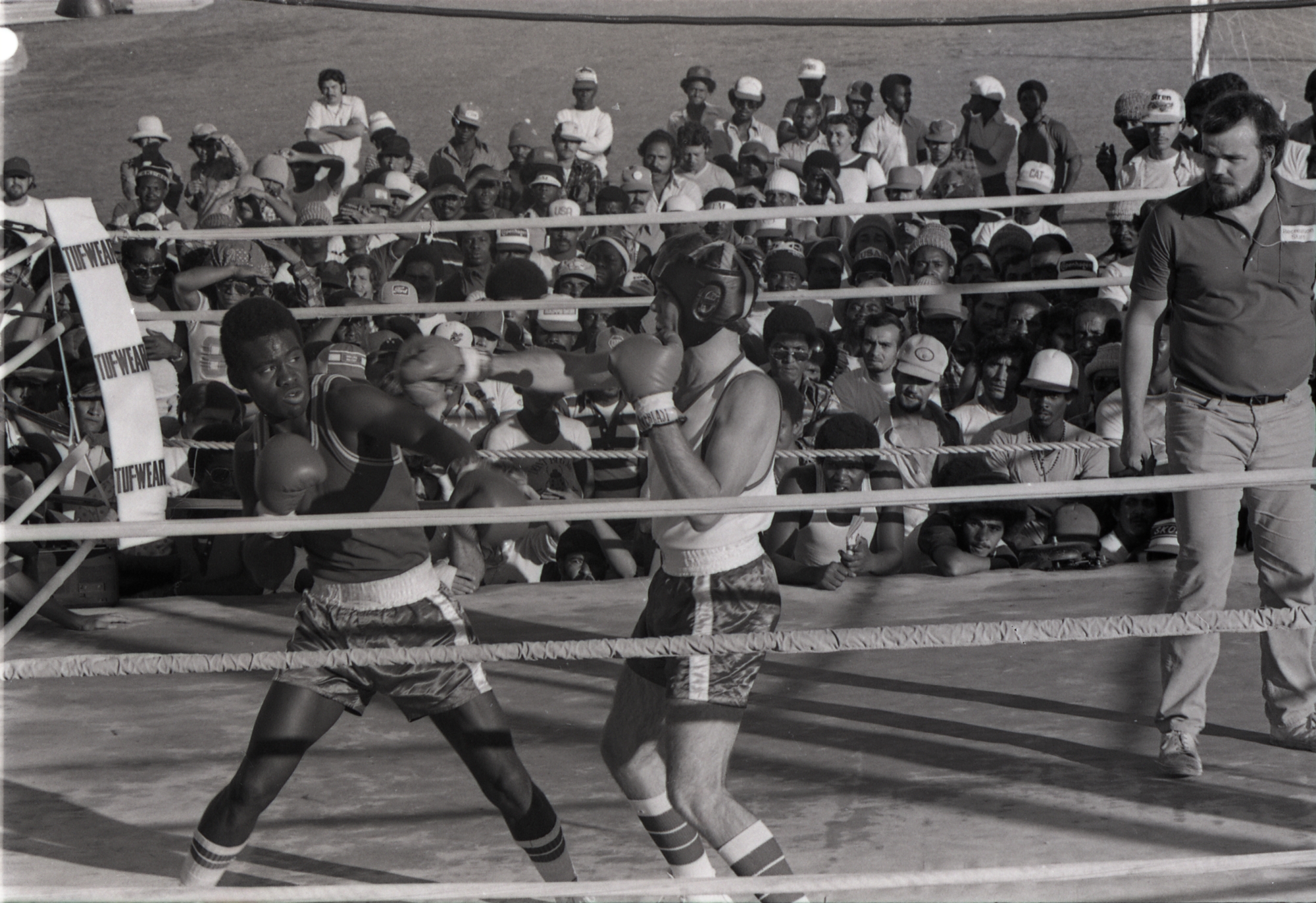 A black and white photograph of two boxers in a boxing ring.